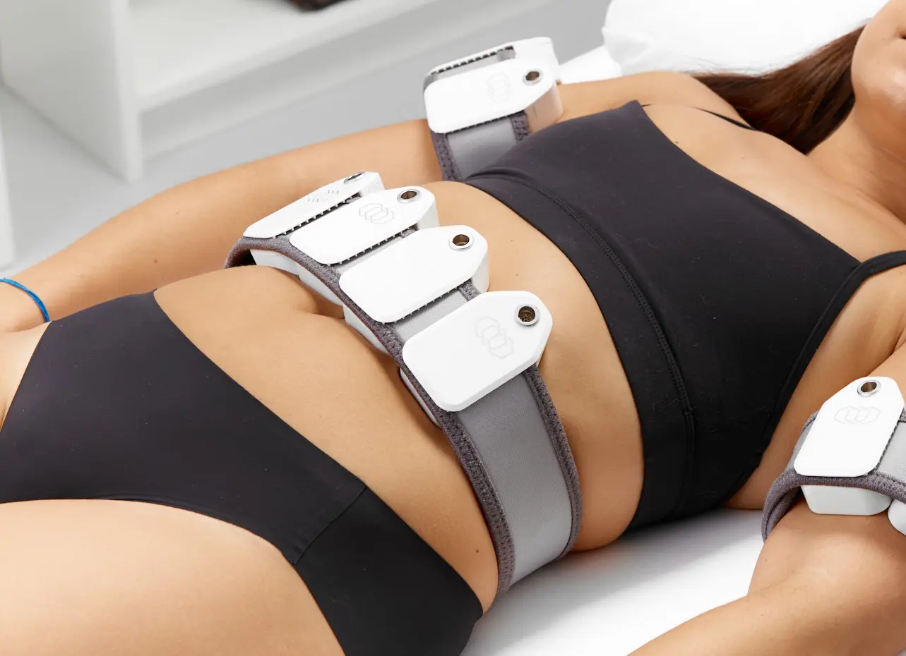A woman is wearing some type of device on her stomach.